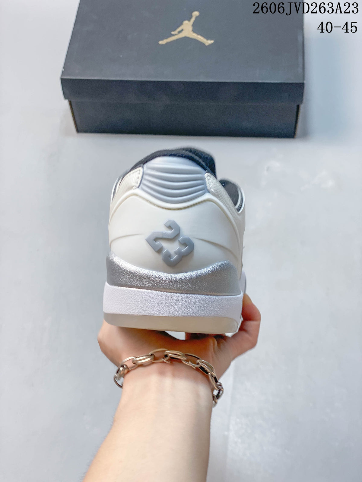 Rear view of the Jordan Sixty Plus Low showing gray heel detailing and a white midsole.