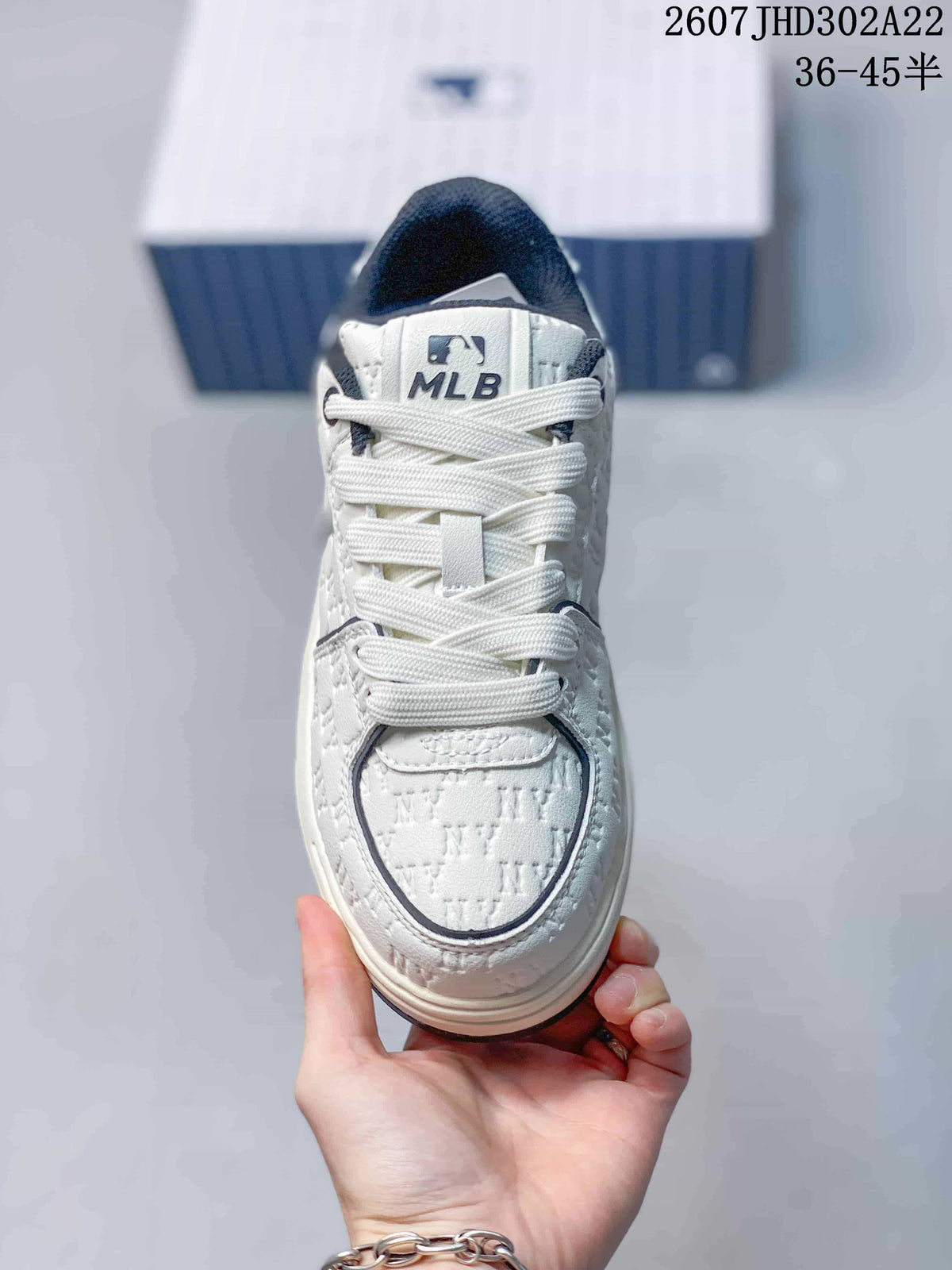 Top view of the sneaker showing white laces, a padded tongue with MLB branding, and the outlined toe box.