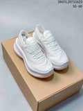 Pair of white Salomon x Comme des Garçons Phantasm 2 sneakers displayed on a box.