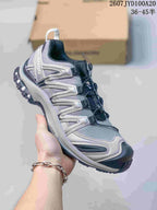Gray, silver and black Salomon XA PRO 3D trail shoe with contrasting outsole details.