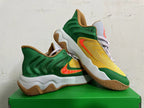 Pair of green and yellow Nike basketball shoes shown at an angle, with orange Swoosh accents and gum outsoles.