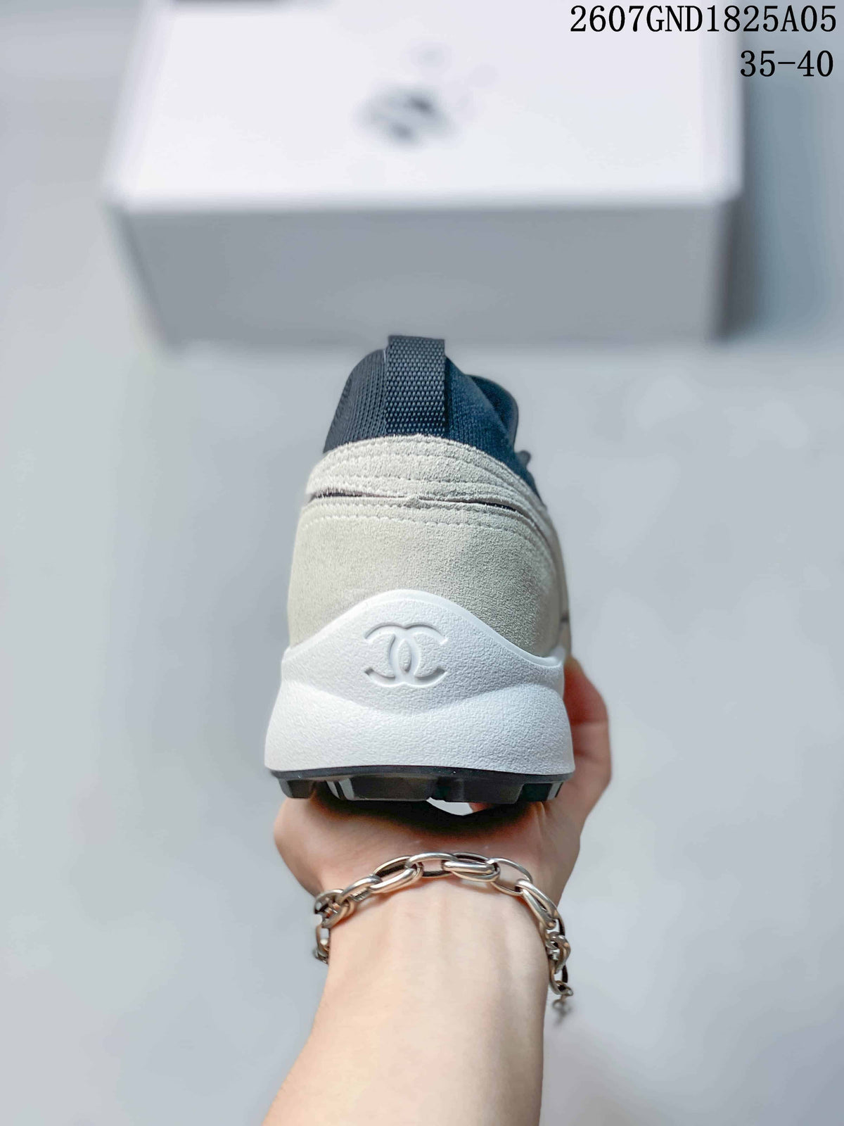 Rear view showing the off-white heel, dark collar, white sole, and Chanel double-C logo.