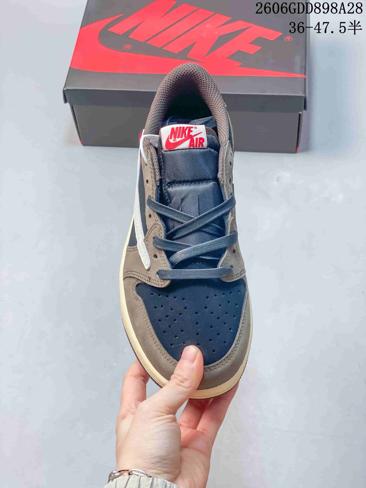 Front view showing a perforated navy toe, taupe overlays, and laces