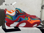 Side view showing the red and multicolor Jordan shoe upper, blue trim and sculpted sole.