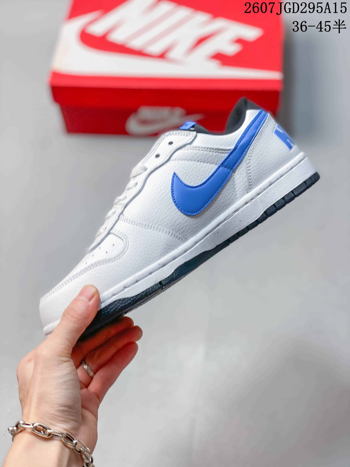 Side view showing the white upper, blue Swoosh, white midsole, and black outsole.