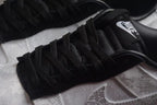 Close-up of the black tongue, black laces, white patterned upper, and side Swoosh.