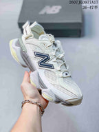 Close side view highlighting the mesh upper, navy branding, heel strap, and chunky outsole.