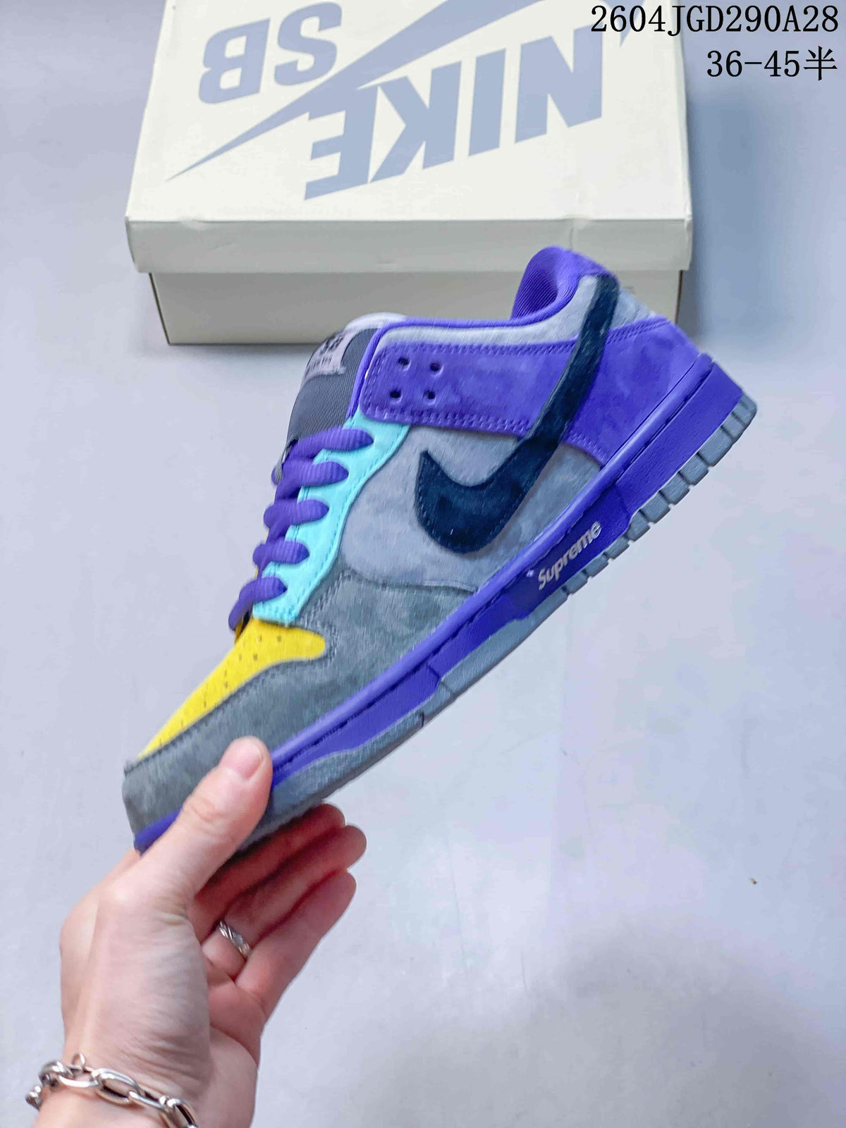 Side view of a low-top sneaker with gray, purple, yellow, and turquoise panels