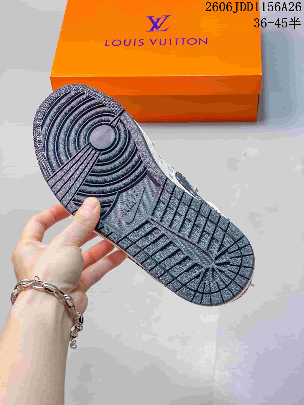 Close view of the dark textured outsole and circular heel tread pattern.