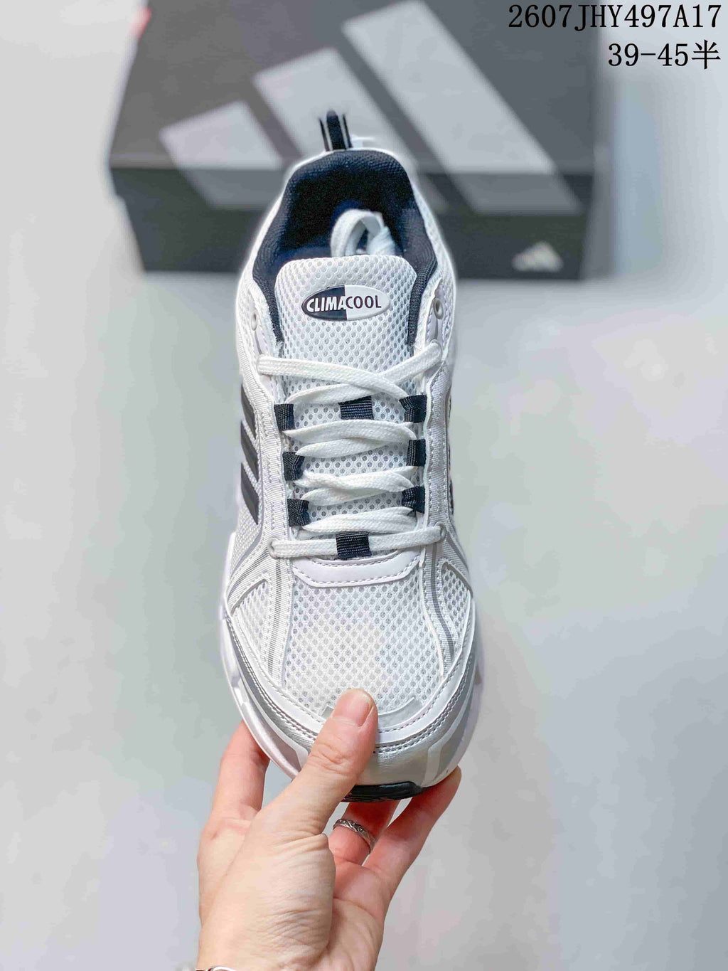 Top view of the white sneaker showing the mesh-style toe box, white laces and Climacool tongue branding; image text shows style code 2607JHY497A17 and size range 39–45.