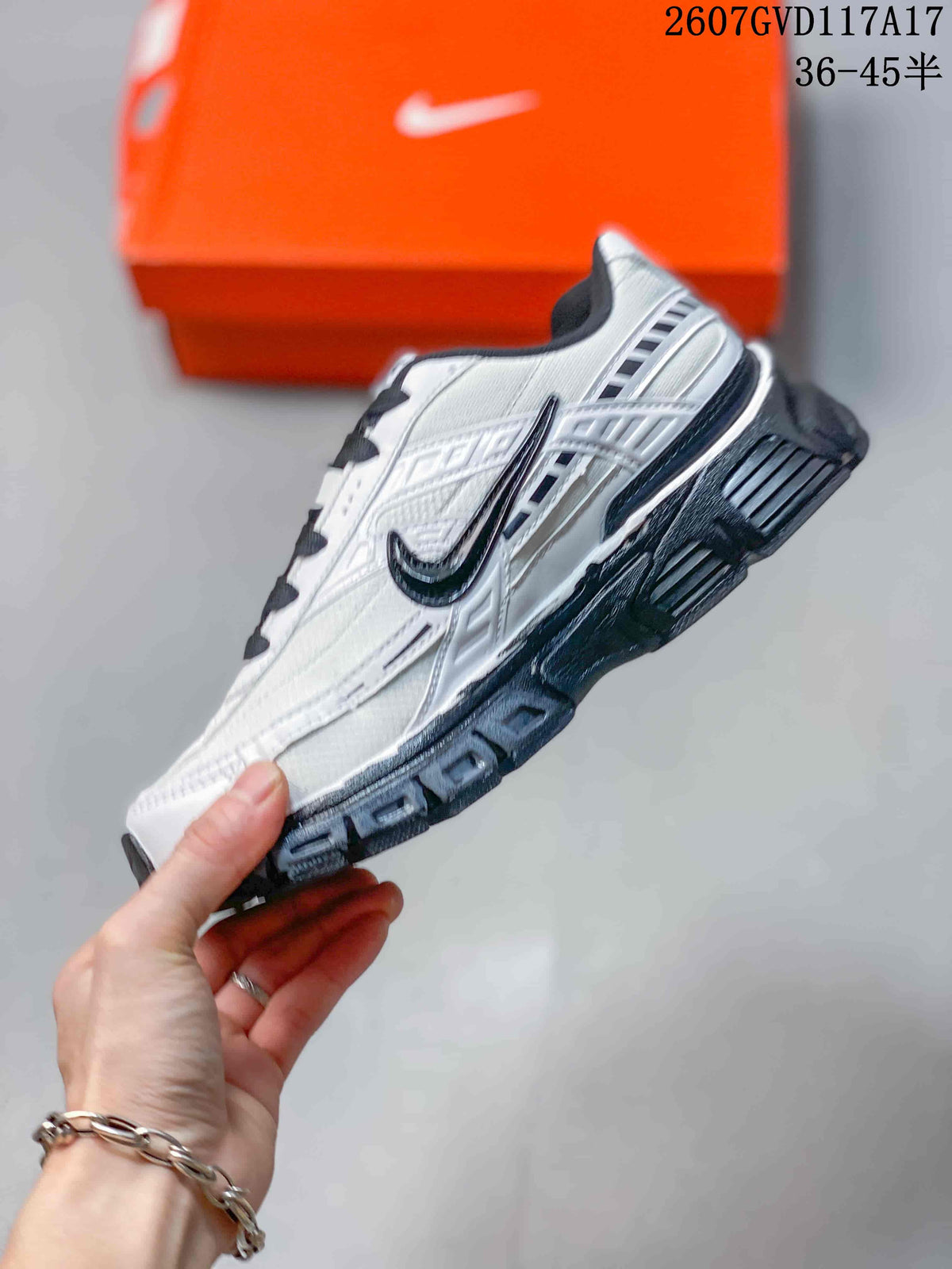 Side view highlighting the white layered upper, black swoosh detailing and thick outsole.
