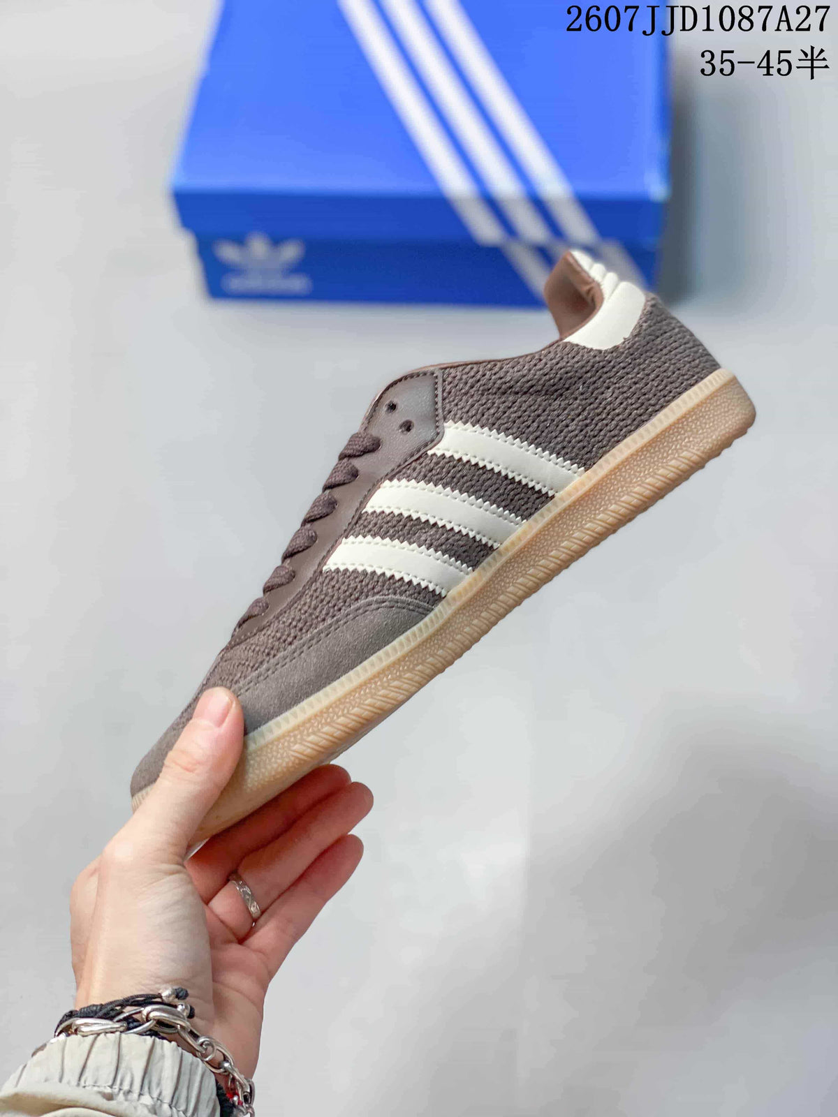Side profile showing the brown upper, white three-stripe design, lace-up front, and gum sole.