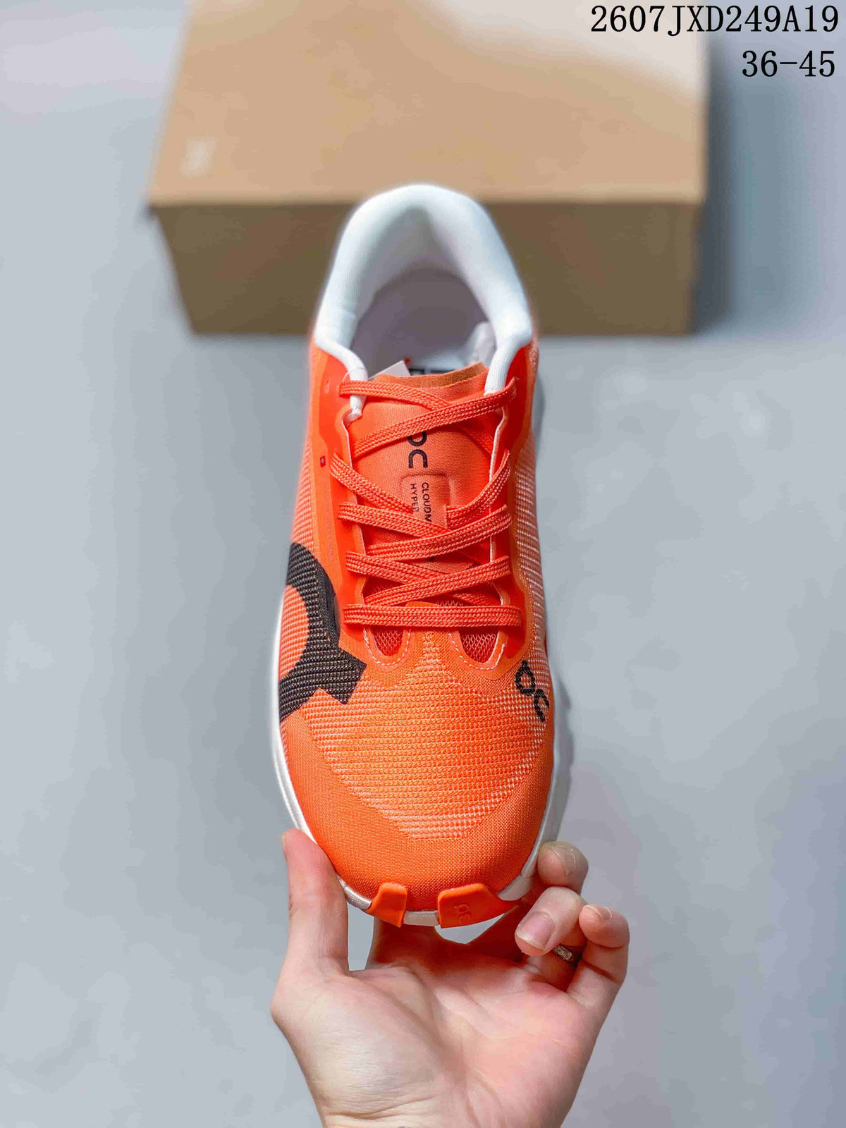 Top view of an orange lace-up sneaker with a textured toe box, white collar, and black side detail.