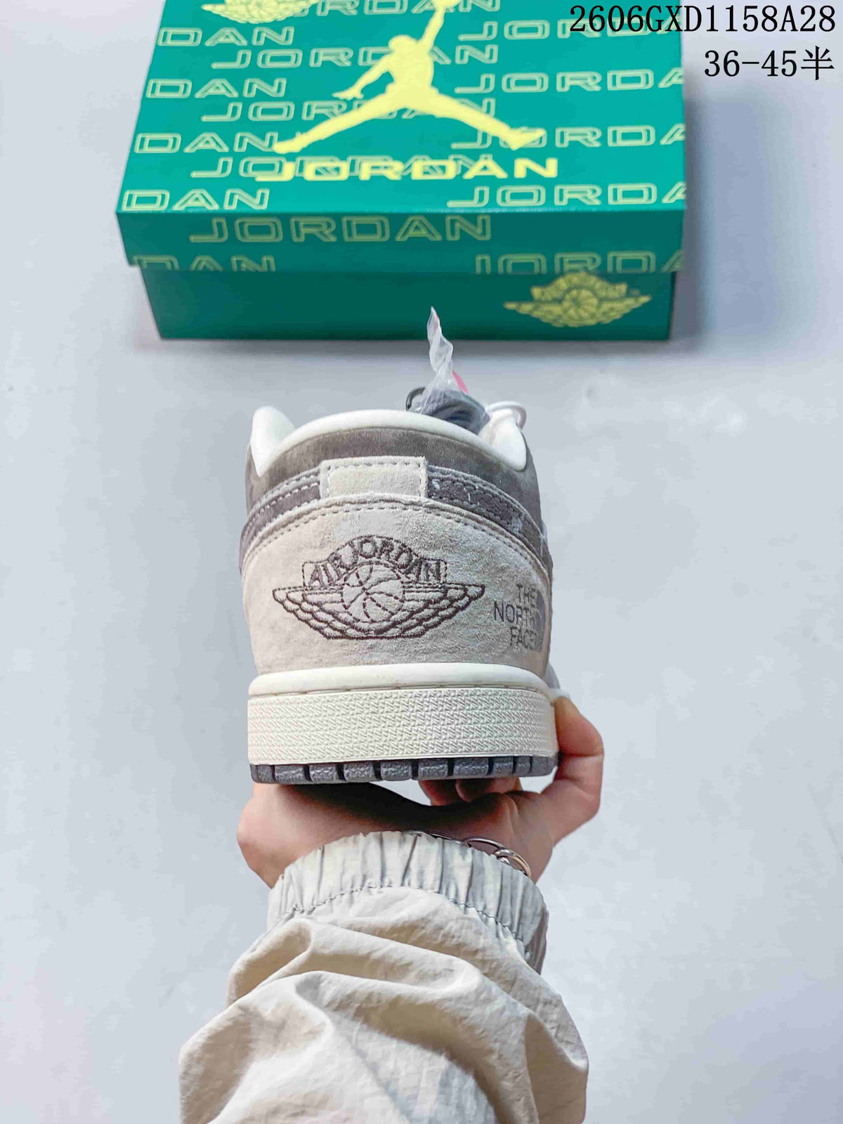 Heel view showing Jordan and The North Face branding on the grey sneaker