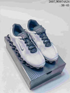 Pair of silver-gray and white Nike Air Liquid Max sneakers displayed on a shoebox; the image shows the listed range 36–45 and style code 2607JWD974A24.
