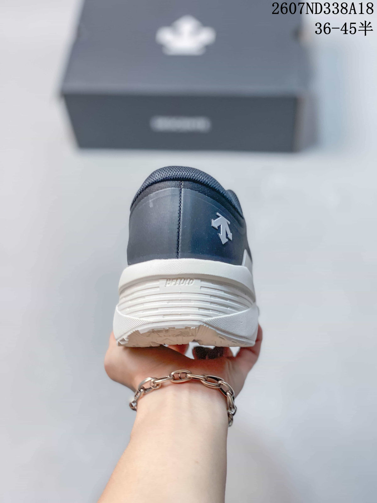 Rear view of the sneaker showing the dark heel panel, white midsole, and heel branding details.