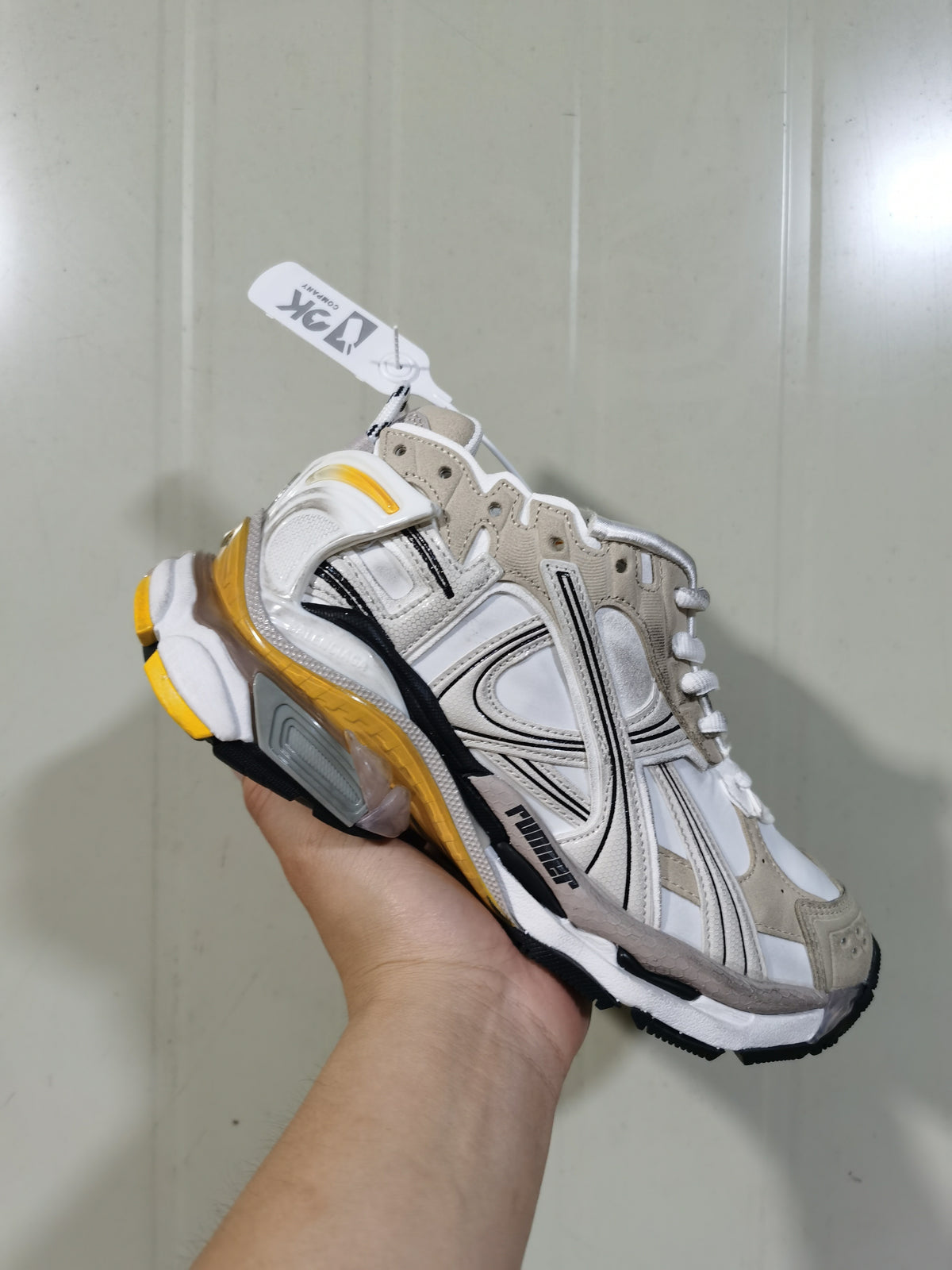 Close three-quarter view of the Puma Runner 9170 sneaker highlighting the lace-up upper, layered construction and contrasting outsole.