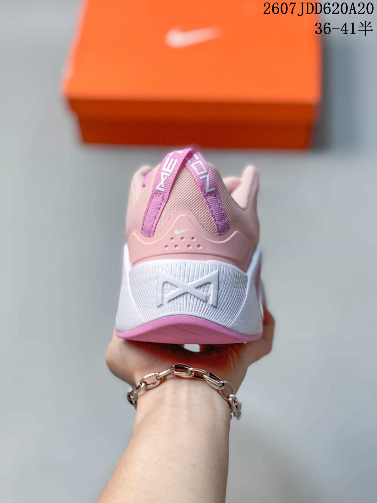 Rear view showing the padded pink heel, white midsole section, heel pull details, and Nike branding.