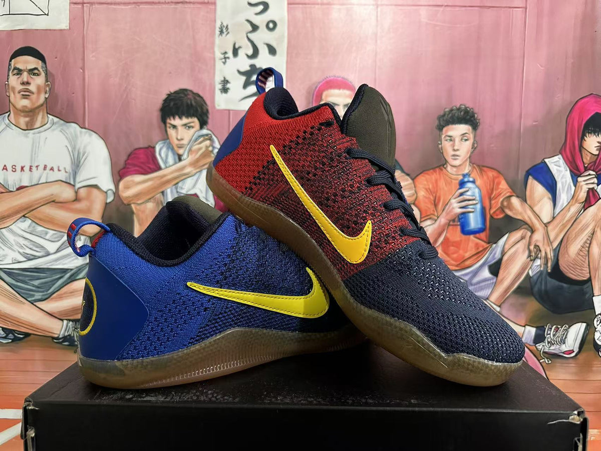 Pair of navy and red basketball shoes with yellow Swoosh details, shown from the side.