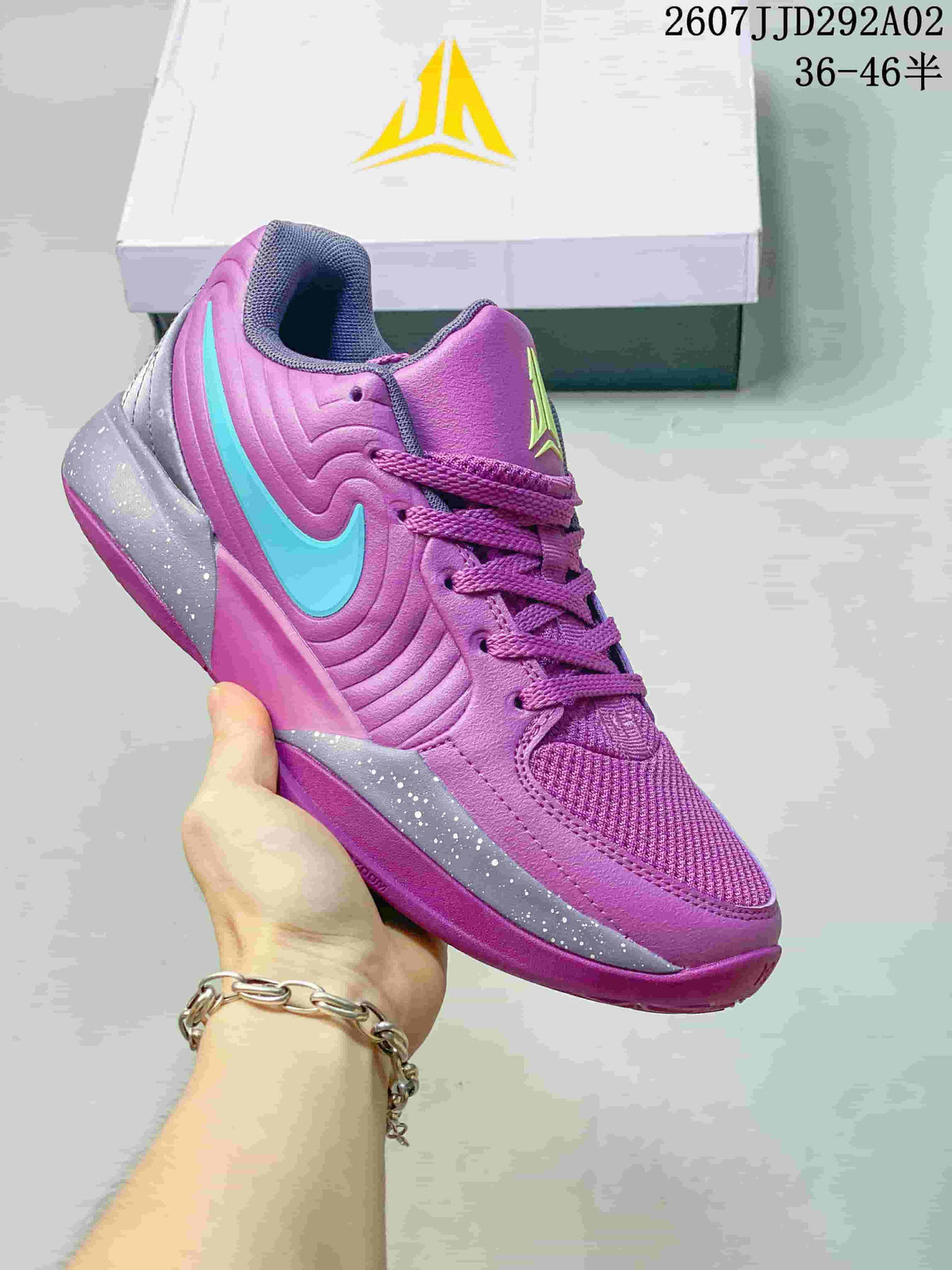 Purple Nike JA 2 basketball shoe with a bright blue Swoosh and speckled grey side detailing.