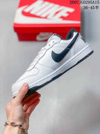 Side profile showing the white layered upper, black side branding, white midsole and dark outsole.