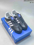 Pair of dark gray and white adidas Samoa sneakers displayed on a blue shoebox; the image shows the size range 40–45.