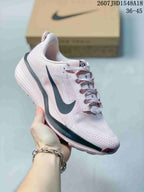 White and pale pink Nike ReactX Pegasus ACG Trail 6 sneaker with a dark Swoosh and pink outsole accents.
