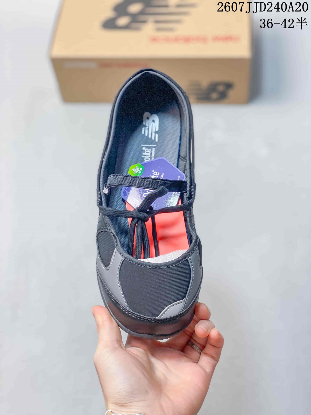 Top view showing the closed toe, contrasting gray overlays, lace-up front, and New Balance insole branding.