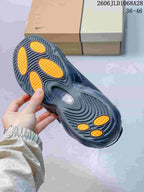 Close-up of the sneaker outsole with orange traction sections.