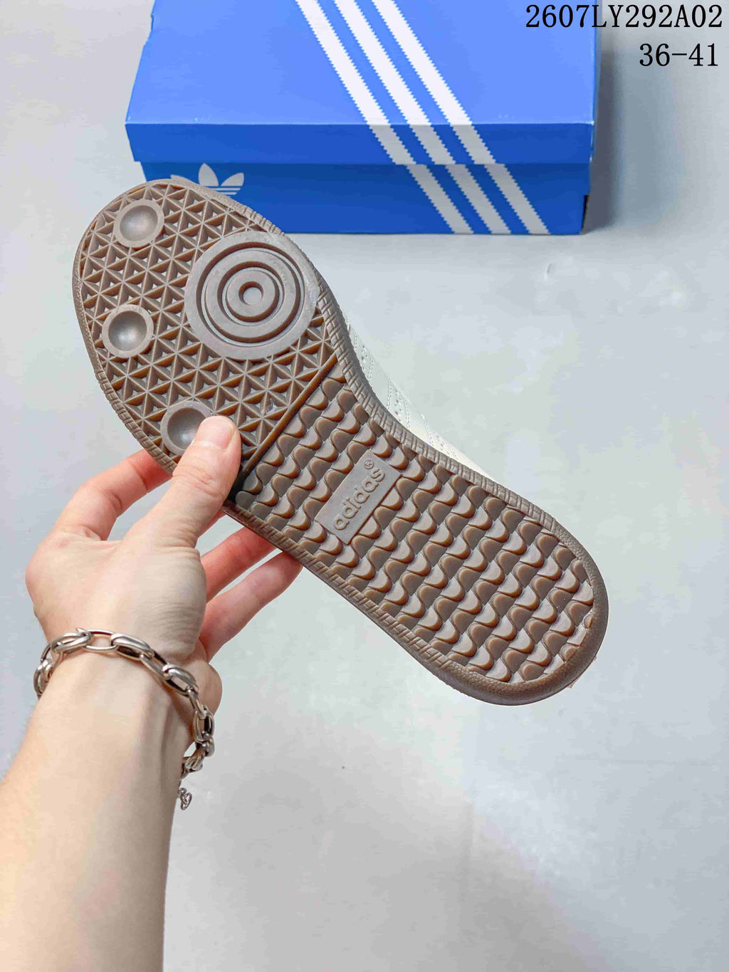 Close view of the textured gum-colored outsole and circular tread pattern of the cream Samba Jane sneaker.