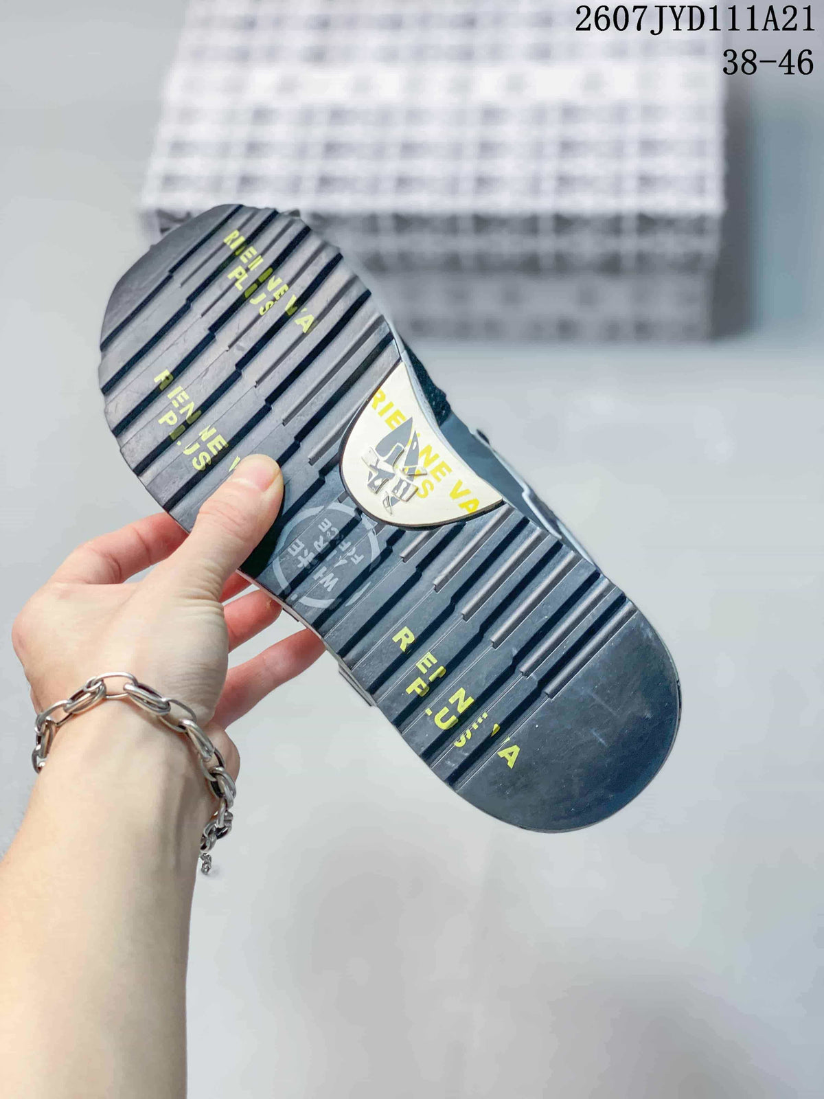 Close view of the sneaker outsole showing raised tread grooves and yellow printed graphics.