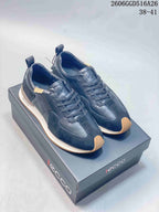 Pair of navy ECCO lace-up sneakers with dark contrasting panels and gum-colored toe accents.