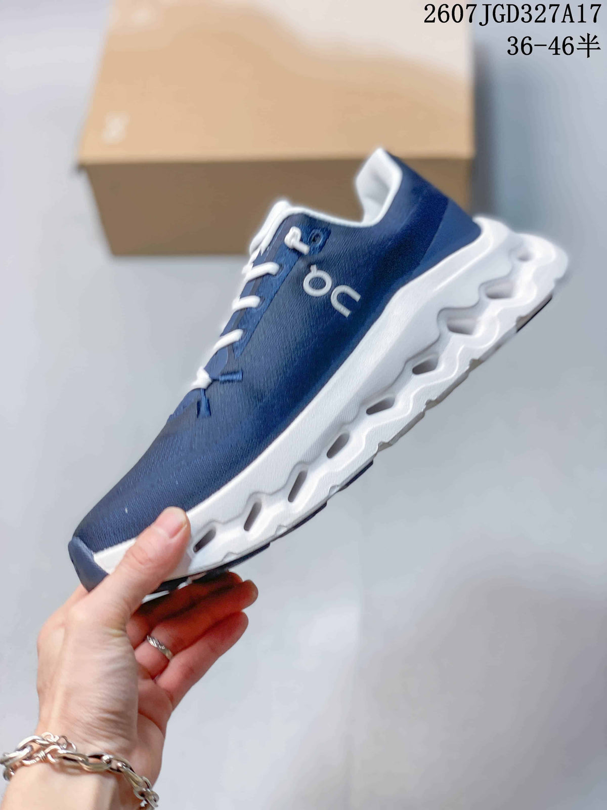 Side profile of a navy On sneaker showing the white laces, side branding, and sculpted white outsole.