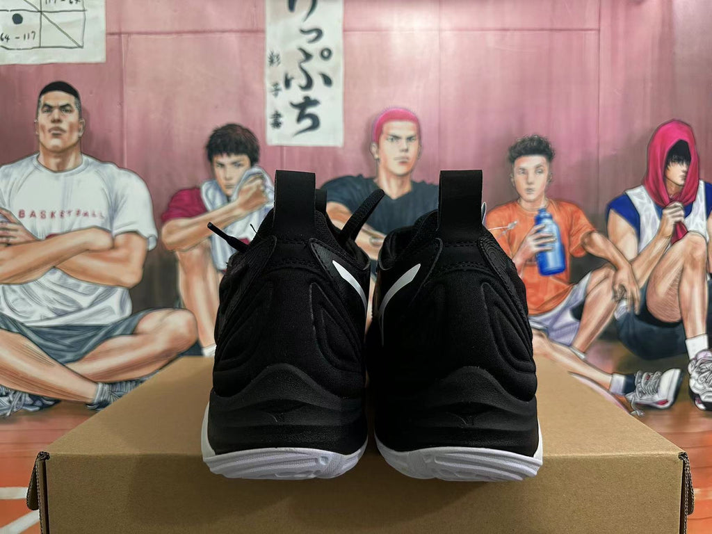 Rear view of black Mizuno Wave Momentum 3 shoes with white outsole accents.