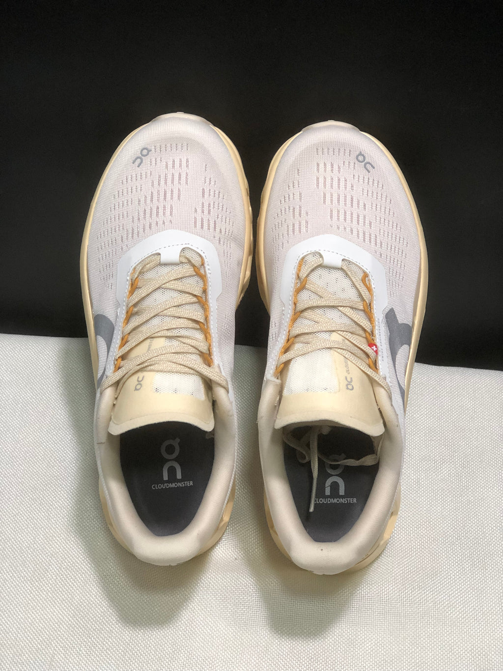 Top view showing the perforated upper panels, laces, tongues, and branded insoles.