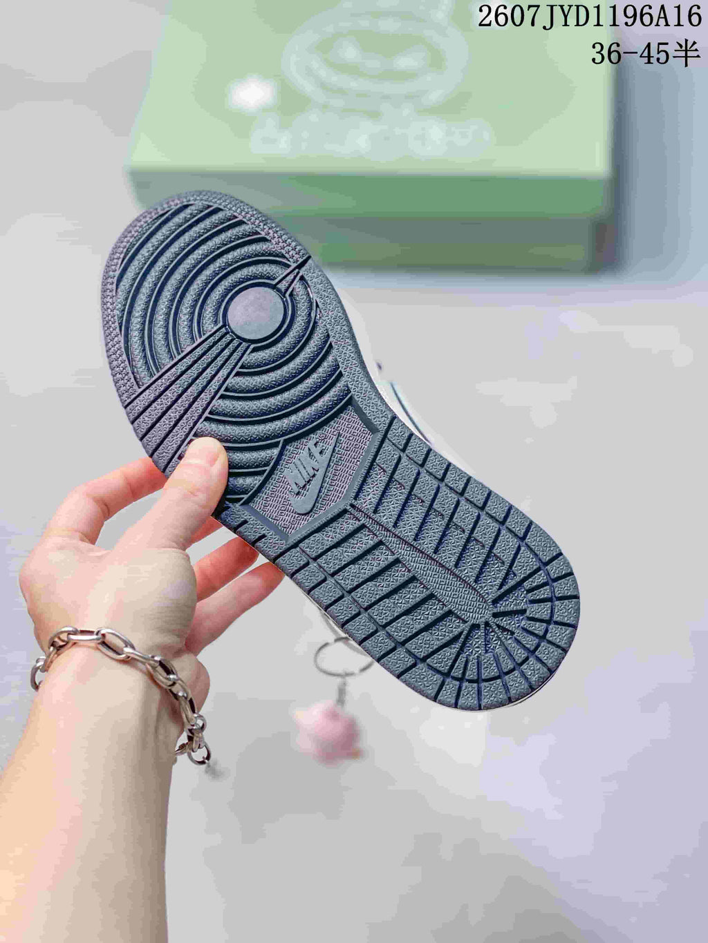 Close view of the patterned outsole with circular and geometric traction grooves.