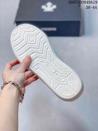 Close-up of the white rubber outsole showing a geometric zigzag traction pattern.