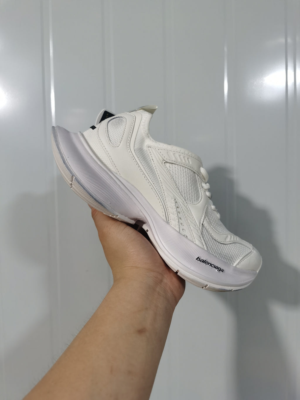 Side view of the white Balenciaga Circuit sneaker showing the mesh upper, layered overlays, curved sole, and Balenciaga branding.