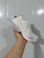 Side view of the white Balenciaga Circuit sneaker showing the mesh upper, layered overlays, curved sole, and Balenciaga branding.