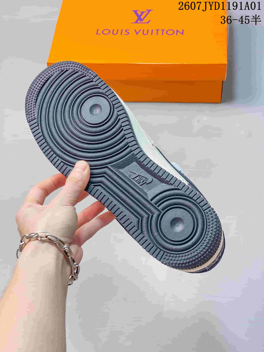 Close-up of the dark outsole with circular traction grooves