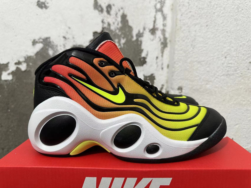 Side view showing the yellow-to-orange gradient upper, bright side logo, and cutout white midsole.
