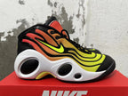 Side view showing the yellow-to-orange gradient upper, bright side logo, and cutout white midsole.