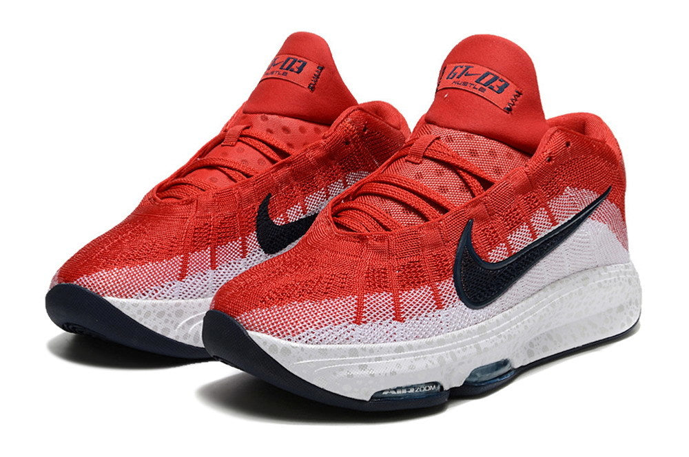 Pair of red and white Nike GT Hustle 3 basketball shoes with dark Swoosh accents.