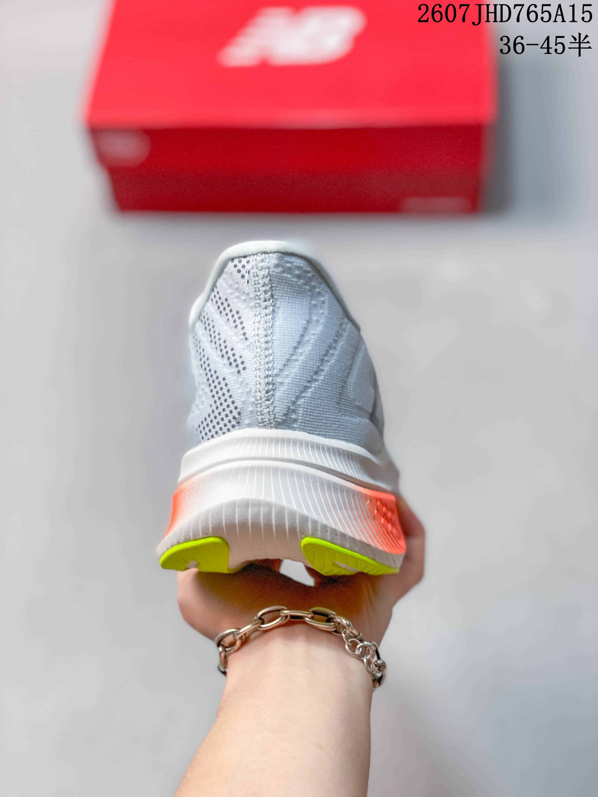 Rear view of the shoe showing the white heel structure, orange side detail, and lime outsole sections.