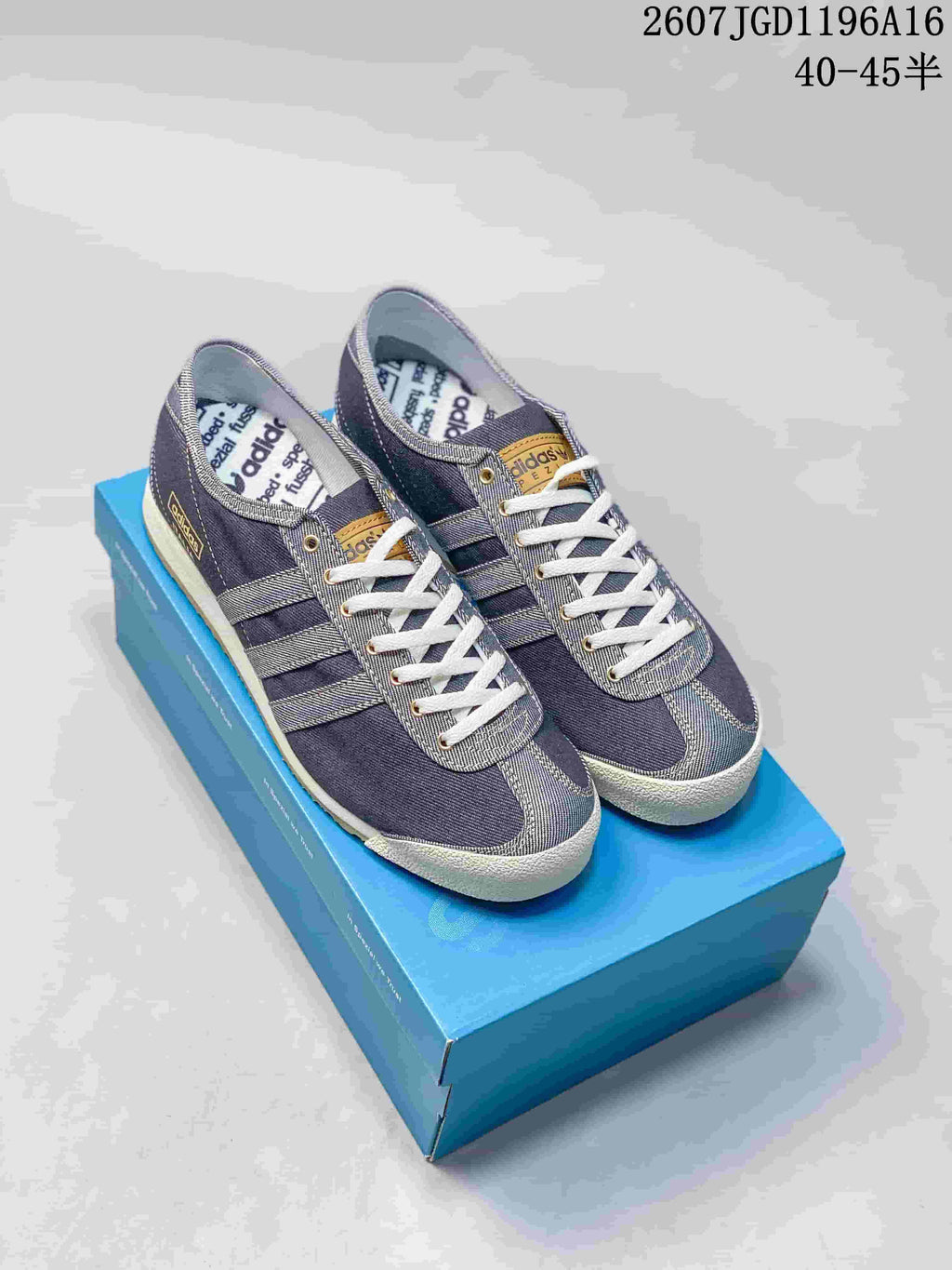 Pair of Blue Bird adidas Spezial-style denim sneakers displayed on a blue shoebox.