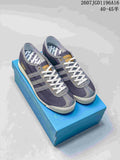 Pair of Blue Bird adidas Spezial-style denim sneakers displayed on a blue shoebox.
