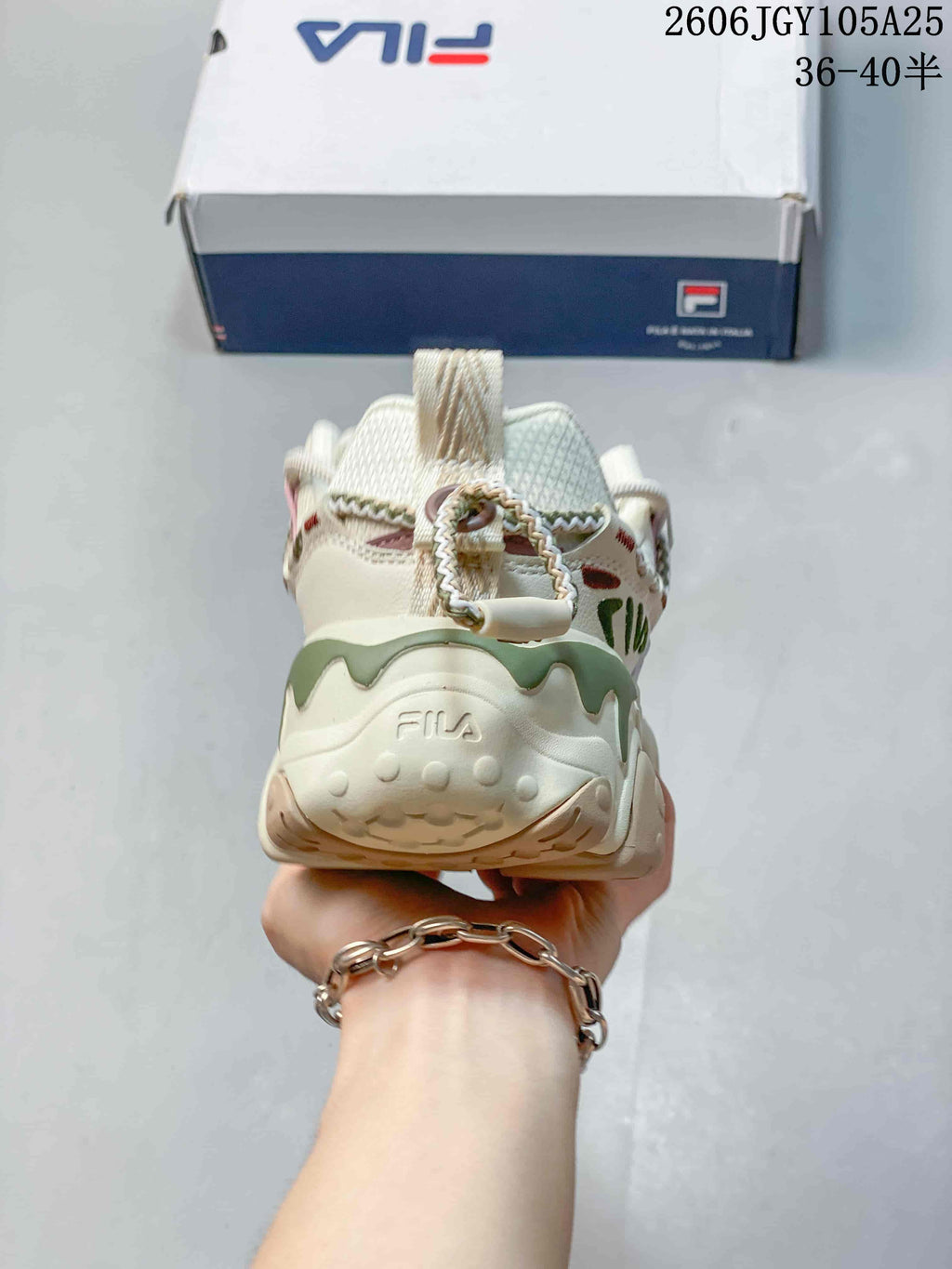 Rear view showing the sculpted heel of a cream FILA Fusion sneaker