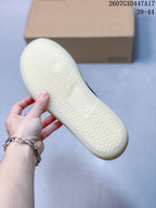 Close-up of the textured light-colored outsole on a white and blue ECCO sneaker.