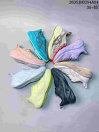 Several ASICS running shoes arranged in a circle, showing assorted colors