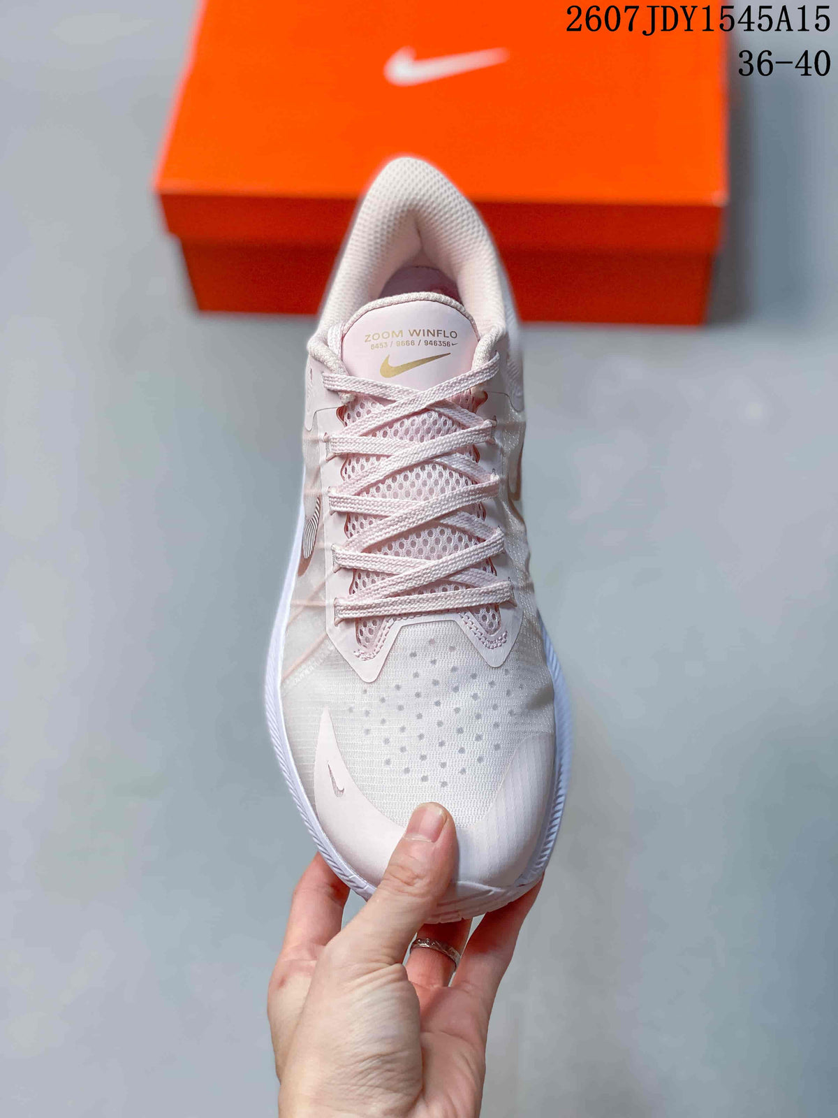 Top view of the sneaker showing the laces, mesh-like tongue area, and perforated toe section.